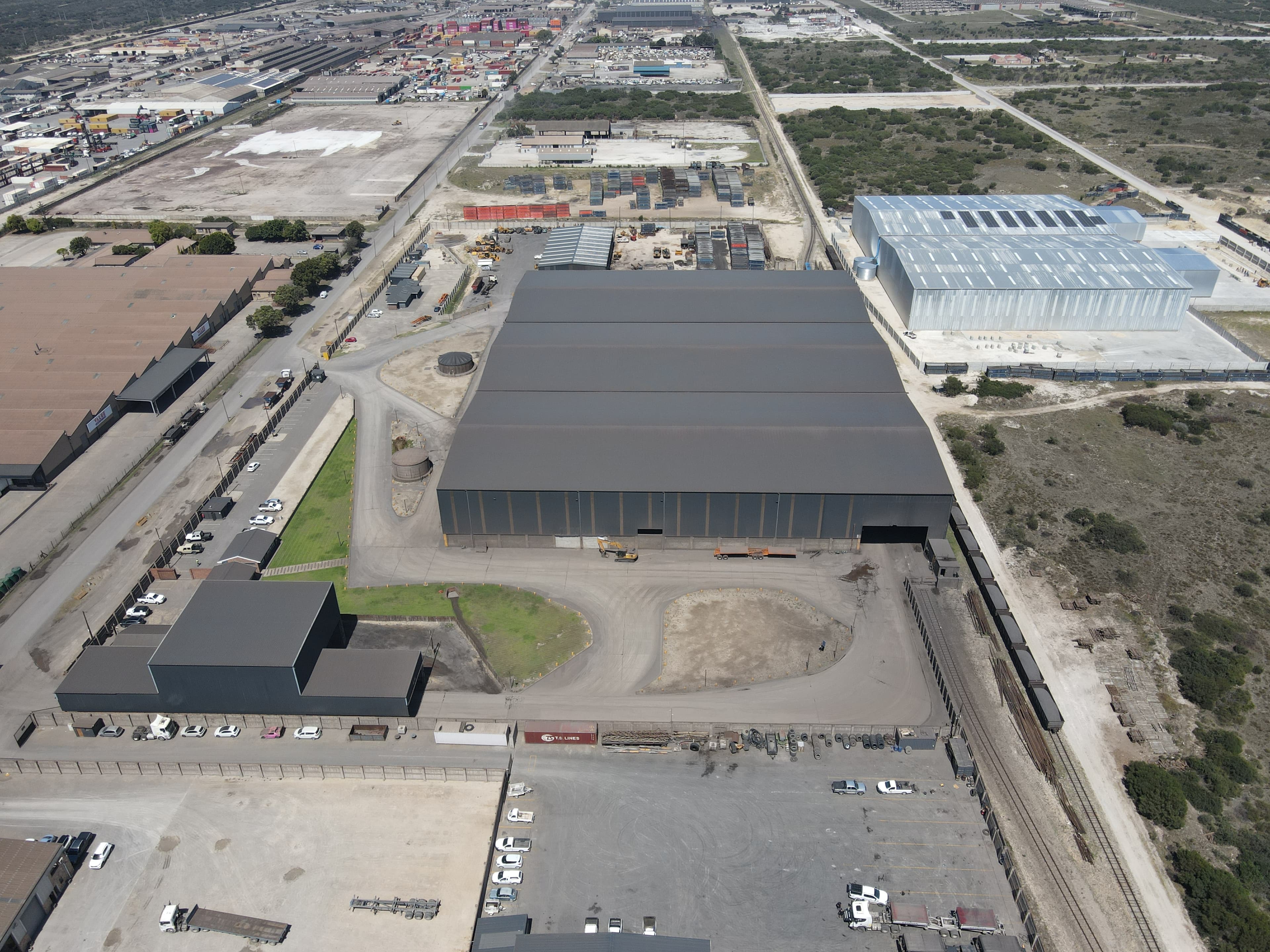 Aerial view of a large industrial site and surrounding logistics area